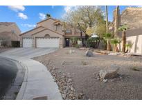 Charming two-story home featuring a spacious three car garage and beautiful desert landscaping at 5 Rampart Ct, Henderson, NV 89074
