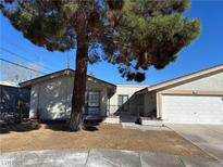 Charming single-story home featuring a well-manicured lawn and an attached two-car garage at 5720 Goldmount Ave, Las Vegas, NV 89107