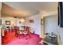 Traditional dining room featuring a chandelier, mirrored wall, and seating for six at 750 S Royal Crest Cir # 345, Las Vegas, NV 89169
