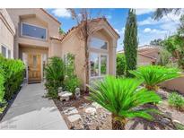 Charming home featuring mature landscaping, a concrete walkway, and a decorative front door at 8170 Round Hills Cir, Las Vegas, NV 89113