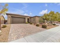 Inviting single-story home featuring a spacious driveway, well-maintained landscaping, and attached two car garage at 8717 Purple Wisteria St, Las Vegas, NV 89131