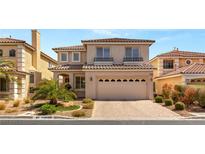 Two-story home featuring desert landscaping, a tile roof, and an attached two-car garage at 10892 Royal Highlands St, Las Vegas, NV 89141