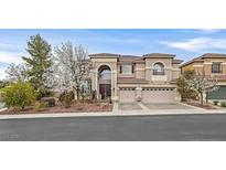 Stunning two-story home with a well manicured lawn and charming curb appeal and three-car garage at 1465 Via Savona Dr, Henderson, NV 89052