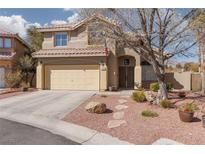 Inviting two-story home featuring desert landscaping, a two-car garage and neutral color palette at 1501 Scenic Peak St, Las Vegas, NV 89144
