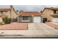 Charming single-story home with a desert landscape and a red tile roof at 1744 La Cruz Dr, Henderson, NV 89014