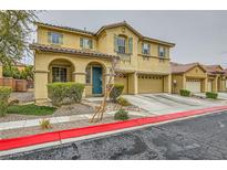 Two-story home featuring an arched entryway, green shutters, and a two-car garage at 208 Summit Creek Ave, North Las Vegas, NV 89031