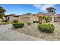Charming single story home featuring desert landscaping, a two car garage and a tile roof in a well maintained neighborhood at 2208 Sawtooth Mountain Dr, Henderson, NV 89044