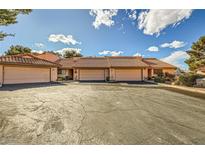 Charming townhome featuring a tile roof, two-car garage, and spacious driveway in a desirable neighborhood at 2611 Laguna Shores Ln, Las Vegas, NV 89121