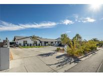 Beautifully renovated home with a modern exterior, spacious driveway, and tasteful landscaping at 2870 Belcastro St, Las Vegas, NV 89117