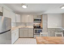 Charming kitchen featuring stainless steel appliances, stylish countertops, and ample cabinet space at 304 Orland St # 38, Las Vegas, NV 89107