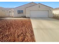 Single-story home with desert landscaping, a two-car garage and a neutral color scheme at 350 Loma Marsh Ct, North Las Vegas, NV 89084