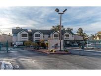 Gated community entrance to The Keys featuring well-maintained landscaping and secure access for residents and visitors at 5151 Lindell Rd # 103, Las Vegas, NV 89118