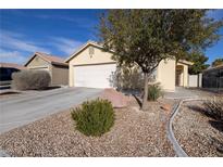 Charming single-story home featuring a well-maintained yard, two car garage, and a welcoming entrance at 5224 Jose Ernesto St, North Las Vegas, NV 89031