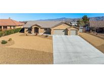 Charming single-story home with a three-car garage, xeriscaping, and mountain views at 5450 Barnwood Ct, Pahrump, NV 89061