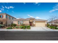 Charming single-story home with a well-manicured front yard and an attached two-car garage at 832 Flowing Meadow Dr, Henderson, NV 89014