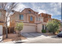 Two-story home featuring a two-car garage and well-manicured landscaping in a residential neighborhood at 9051 Iron Cactus Ave, Las Vegas, NV 89148