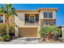 Charming two-story home with a stone facade, balcony, and well-manicured landscaping at 949 Via Stellato St, Henderson, NV 89011