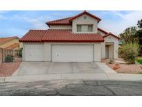 Two-story home featuring a red tile roof, a three-car garage, and low-maintenance landscaping at 9529 Shallow Brook Cir, Las Vegas, NV 89117