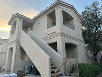 A welcoming two-story exterior view of the home with private balconies and landscaped surroundings at 1881 W Alexander Rd # 2095, North Las Vegas, NV 89032