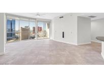 Bright living room with floor-to-ceiling windows offering panoramic city views and access to a private balcony at 200 W Sahara Ave # 3004, Las Vegas, NV 89102