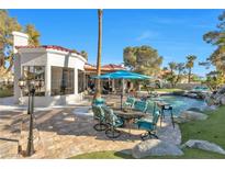 Beautiful backyard featuring a custom pool, outdoor seating and lush landscaping, perfect for entertaining at 2101 Diamond Bar Dr, Las Vegas, NV 89117