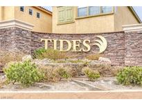 Stone sign for 'The Tides' community in a landscaped entrance, welcoming residents and guests at 3525 Hammock St, Las Vegas, NV 89147