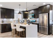 Well-lit kitchen featuring stainless steel appliances, sleek countertops and stylish lighting at 3645 E Viking Rd, Las Vegas, NV 89121