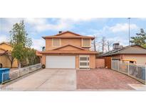 Two-story home featuring a large driveway, a two-car garage, and low-maintenance landscaping at 3744 Archer St, Las Vegas, NV 89108