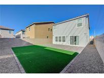 A spacious backyard features artificial turf, a patio area, and block wall fencing for added privacy at 5691 Tinar St, Las Vegas, NV 89113