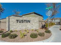 Stone entrance sign to the Tustin community, with desert landscaping and blue skies at 5691 Tinar St, Las Vegas, NV 89113