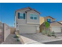 Charming two-story home showcasing a well-manicured yard, attached two car garage, and neutral color palette at 5691 Tinar St, Las Vegas, NV 89113