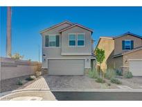 Two-story home featuring a spacious two-car garage and low maintenance desert landscaping at 5691 Tinar St, Las Vegas, NV 89113