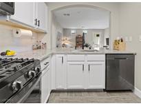 Modern kitchen featuring white cabinets, granite countertops, and stainless steel appliances at 6645 Churnet Valley Ave, Las Vegas, NV 89139
