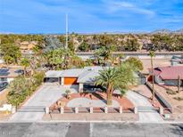Charming single-story home featuring well manicured yard, a circular driveway, and mature landscaping at 7748 Firethorn Ln, Las Vegas, NV 89123