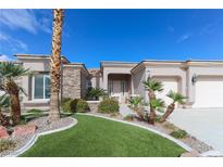 Charming single-story home features a well-manicured lawn, desert landscaping and stone accents at 809 Lake Hill Dr, Boulder City, NV 89005