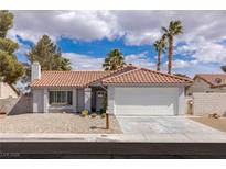 Charming single-story home with a well-manicured front yard and a two-car garage at 8198 Palmada Dr, Las Vegas, NV 89123