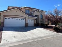 Charming two-story home with a three-car garage and manicured landscaping at 9123 Imperial Castle Ct, Las Vegas, NV 89147