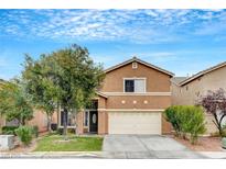 Two-story home with a well-manicured lawn, mature trees, and an attached two-car garage at 9992 Oyster Pearl St, Las Vegas, NV 89183
