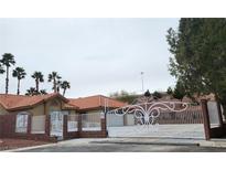 Charming single-story home featuring a terra cotta roof, desert landscaping and gated entry way at 1163 Spanish Armada Rd, Las Vegas, NV 89123