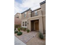 Charming two-story townhome with a private balcony and desert landscaping at 1187 Kiamichi Ct, Henderson, NV 89002