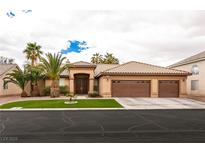 Spacious one-story home featuring a three-car garage and well manicured desert landscaping at 1313 Gallery Oaks Dr, Las Vegas, NV 89123