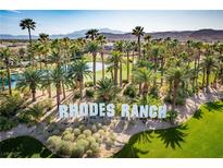 Beautiful Rhodes Ranch neighborhood entrance features lush landscaping and a refreshing pond at 168 Springhouse St, Las Vegas, NV 89148