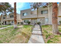 Two-story townhome with a well-maintained lawn, a concrete walkway, and desert landscaping at 2632 Matogroso Ln, Las Vegas, NV 89121