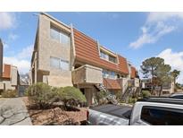 Condo building featuring red tiled roof, textured facade, and well-kept landscaping at 3597 Arville St # 201B, Las Vegas, NV 89103
