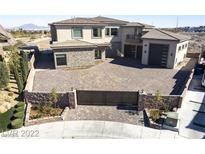 Stunning home featuring a private, gated entrance and elegant paver driveway, showcasing curb appeal at 386 Cactus River Ct, Henderson, NV 89074
