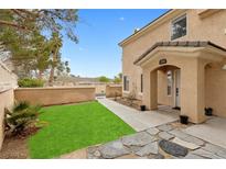 Inviting home exterior featuring a well-maintained lawn and covered entryway at 3950 S Sandhill Rd # 132, Las Vegas, NV 89121