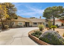 Charming single-story home with a well-manicured front yard and circular driveway, perfect for Gathering living at 4795 W Maulding Ave, Las Vegas, NV 89139