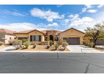 Beautiful single-story home featuring a tile roof, three-car garage and desert landscaping at 10260 Hawks Wing St, Las Vegas, NV 89178