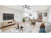 Open-concept living room features modern furnishings, light wood floors, and contemporary design elements at 105 Ash St, Henderson, NV 89015