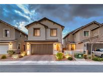 Charming two-story home with a brick driveway and well-manicured landscaping at 122 Cabaletta Ln, Henderson, NV 89015